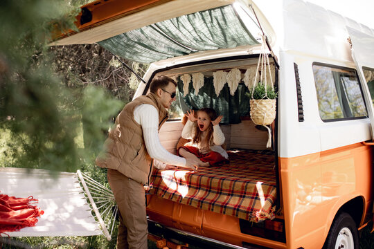 Dad plays and has fun with his daughter on a trip, family vacation. Naughty kids. motorhome, caravan driver, trailer. Traveling with children, fatherhood, father's day