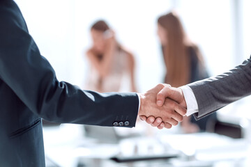 handshake of business people in the background of the office