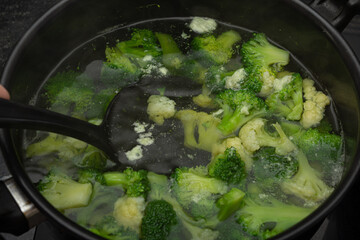 Cooked brocolli on steam in a bowl