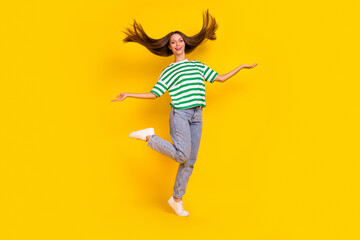 Full length portrait of pretty cheerful lady hands throw flying hairdo isolated on yellow color background