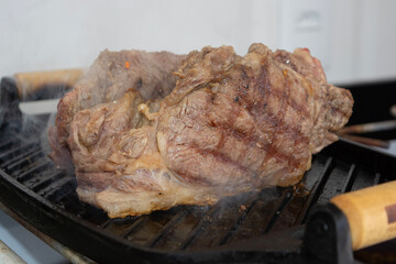 two sirloin steaks being grilled on iron cast