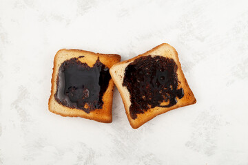 Aussie savory toasts for breakfast. Vegemite is a very popular yeast based spread in Australia. Grey textured background, copy space