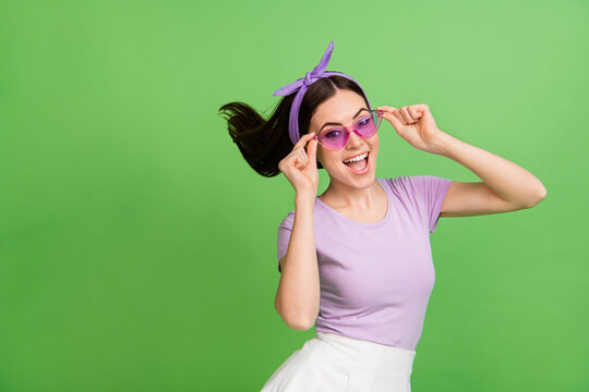 Photo of impressed young brunette lady wear band glasses t-shirt isolated on green color background