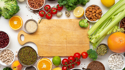 Cooking concept empty chopping board and vegetables top view