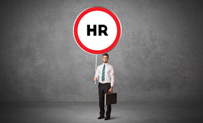 Young business person holdig traffic sign