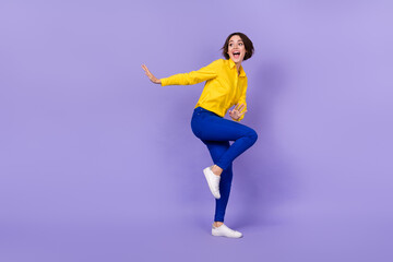 Fototapeta na wymiar Full length photo of funky young brunette lady dance wear shirt trousers footwear isolated on purple background