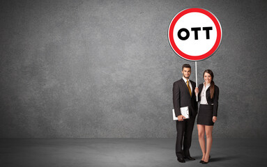 Fototapeta premium Young business person holdig traffic sign