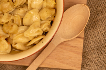 Boiled with spices dumplings with meat in a ceramic bowl. Close-up, selective focus