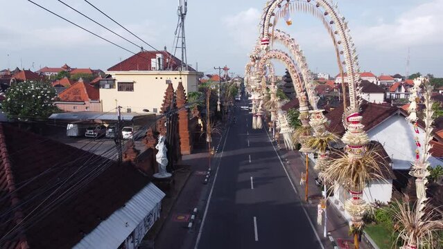 Aerial Drone of Street in Bali, Indonesia Kerobokan Decorated by Penjors Decorative Bamboo Poles during Galungan Kuningan Day