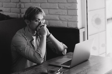 Male getting bad news on laptop in cafe. Sad guy looking laptop screen