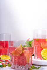 Refreshing homemade pink rhubarb lemonade. Cold summer drink raw rhubarb, lime slices and mint, copy space