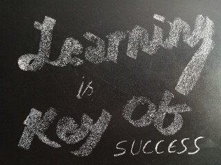 Motivational words on chalkboard concept.