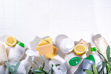 Eco friendly organic cleaning concept. Eco-friendly cleaner utensils - eco brushes, tools sponges, natural cleaning products, soda, soap, lemon, vinegar, bottles with green leaves on white background