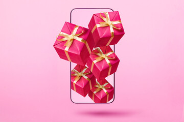 Gift boxes flying from smartphone on pink background. Online win, gift, lottery or shopping concept.
