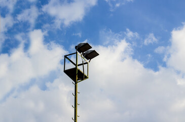 Stadium lamp in blue sky with copy space