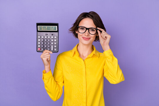Photo of nice young lady hold calculator wear yellow outfit eyewear isolated on violet color background