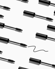 Creative pattern of mascara brushes on white background. Make up products.