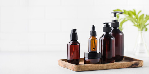 Different brown glass bottles with eco friendly organic beauty products. Concept natural DIY cosmetics.