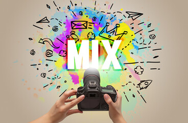 Close-up of a hand holding digital camera with abstract drawing