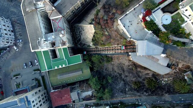 Aerial top down of a carriage going up in El Peral funicular in Cerro Alegre, Valparaiso hillside city, Chile