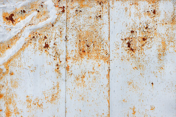 Texture of an old rusty metal sheet covered with peeling paint.