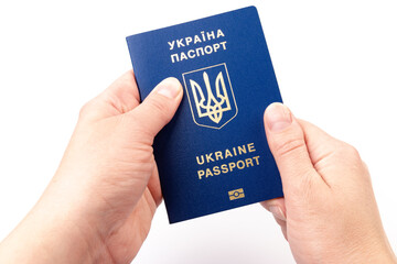 Passport of a citizen of Ukraine in a female hand on white background, close-up. Inscription in Ukrainian Ukraine Passport