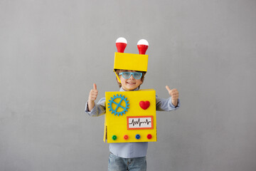 Happy child with robot have an idea