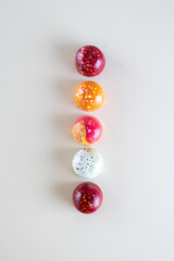 Modern hand painted with different colors  chocolate candy placed in a row. Product advertising concept
