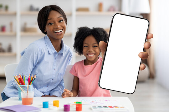 Black Girl With Blank Smartphone In Hand Posing At Home With Mom