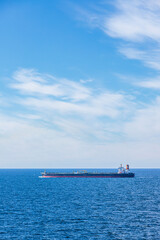 Fototapeta premium The crude oil tanker Olympic Flag on a calm sea under a blue sky in The Skagerrak off Denmark