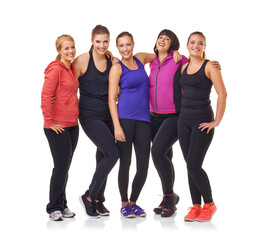 Committed to fitness. A group of excited women of different body shapes standing isolated on white while wearing sportswear.