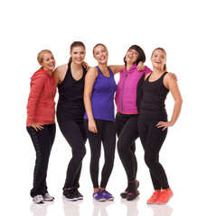 Obraz premium Committed to fitness. A group of excited women of different body shapes standing isolated on white while wearing sportswear.