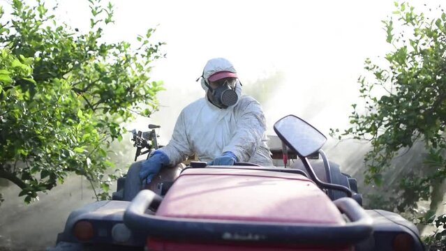 Tractor spraying pesticide drone aerial view, pesticides or insecticide spray on lettuce or iceberg field. Pesticides and insecticides on agricultural field in Spain