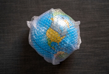 Globe wrapped in bubble wrap plastc still life