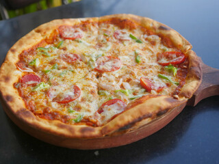 Indian Vegetarian cheese Pizza topped with tomatoes, capsicum and onion. veg pizza in india