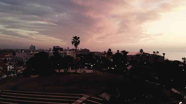 A drone flying through the amphetheater to the sunset at Jaffo 4K