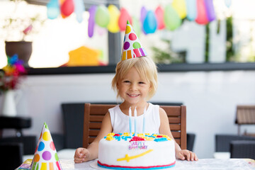 Adorable happy child, little kid boy celebrating his birthday