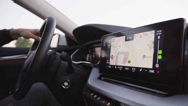 A map and GPS on the touchscreen system on the dashboard in a driven car - closeup