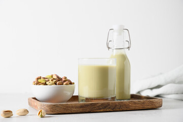 Nutty vegan homemade Pistachio milk on white background. Diary free. Vegan plant based milk.