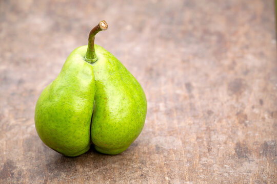 A pear looks like a botty bottom, cellulite skin or weight loss diet concept with copy space