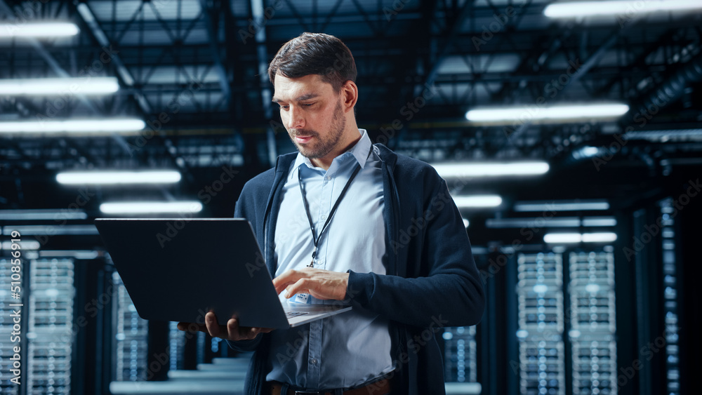 Leinwandbilder Successful Data Center IT Specialist Using Laptop Computer. Server Farm Cloud Computing Facility with System Administrator Working. Data Protection Engineering Network for Cyber Security.