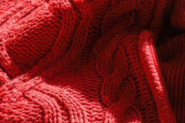 Closeup of the details and textures of a red coat made from sheep's wool