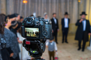 View to the camera display recording Jewish chasid wedding