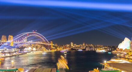 Colourful Light show at night on Sydney Harbour NSW Australia. The bridge illuminated with lasers...