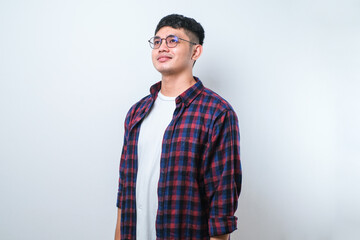 Young handsome asian man looking away to side with smile on face, natural expression. Laughing confident.