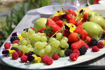 Fruit salad featuring grapes, apples, strawberries, raspberries and blackberries.
