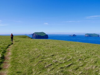 Woman hiking on Westman Islands, Heimaey, Iceland.