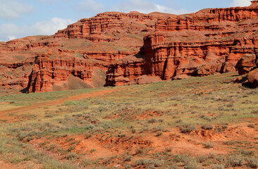 Landscape with red mountains Narman Peribacalari, formed due to erosion and weathering, against the blue sky with clouds, near the city of Erzurum, in the region of Eastern Anatolia, Turkey