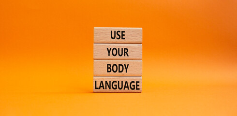 Use your Body Language symbol. Concept words Use your Body Language on wooden blocks. Beautiful orange background. Business and Use your Body Language concept. Copy space