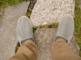 Feet on the paving stones in the square.